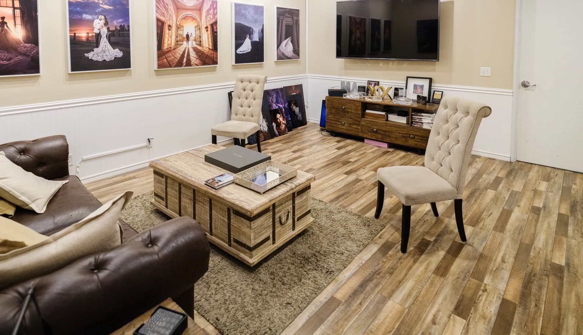 Framed portrait artwork displayed beside seating in the Valencia studio
