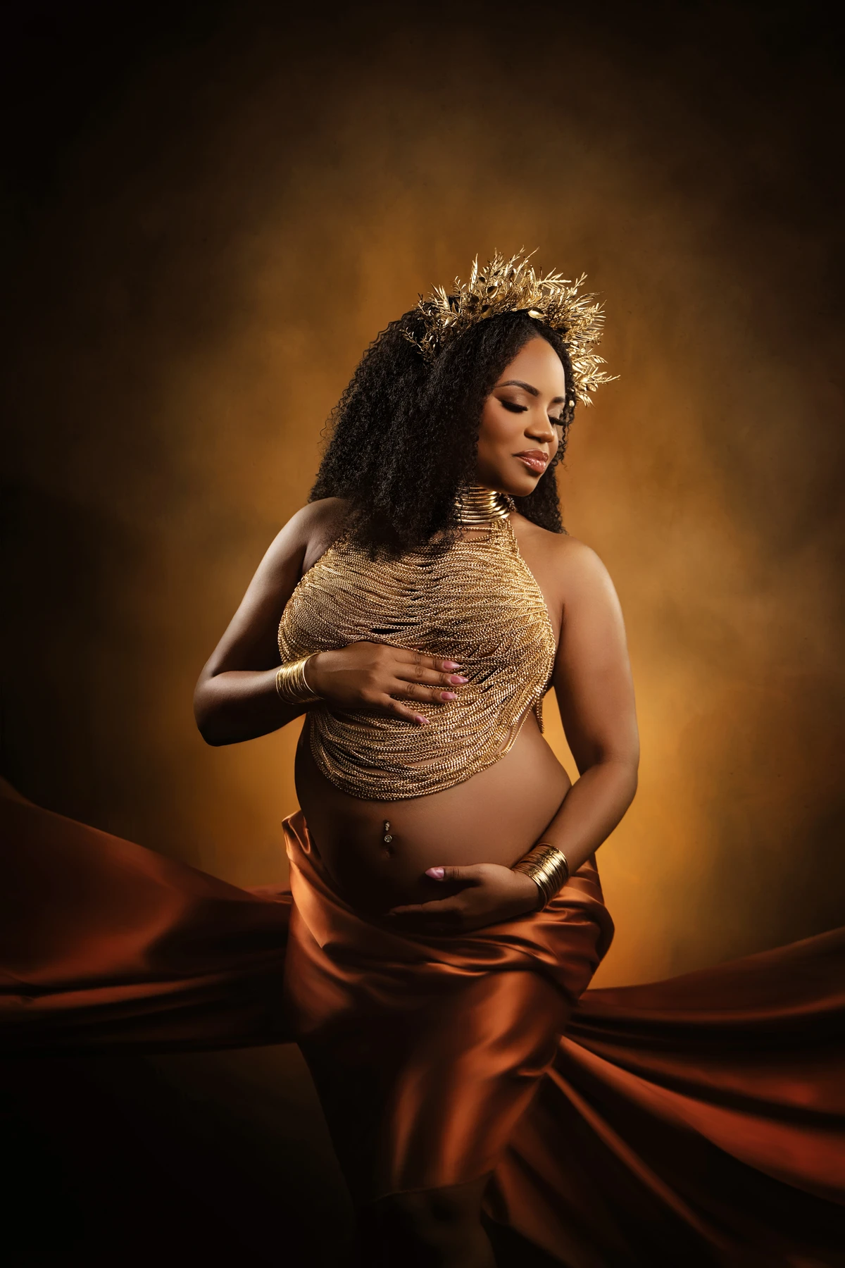Maternity portrait with copper fabric and a gold headpiece
